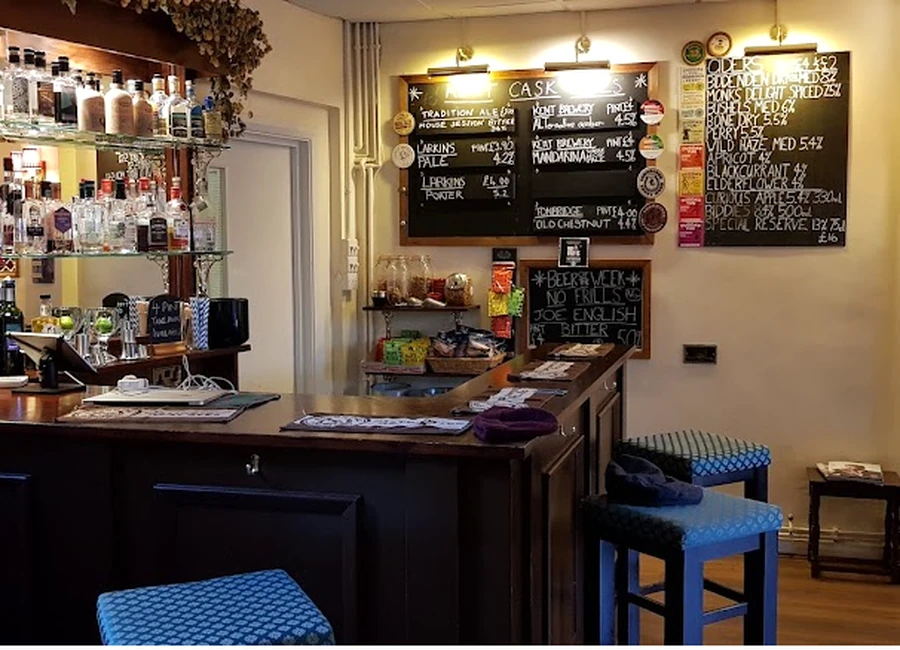 The wooden bar with chalkboards showing ales and ciders