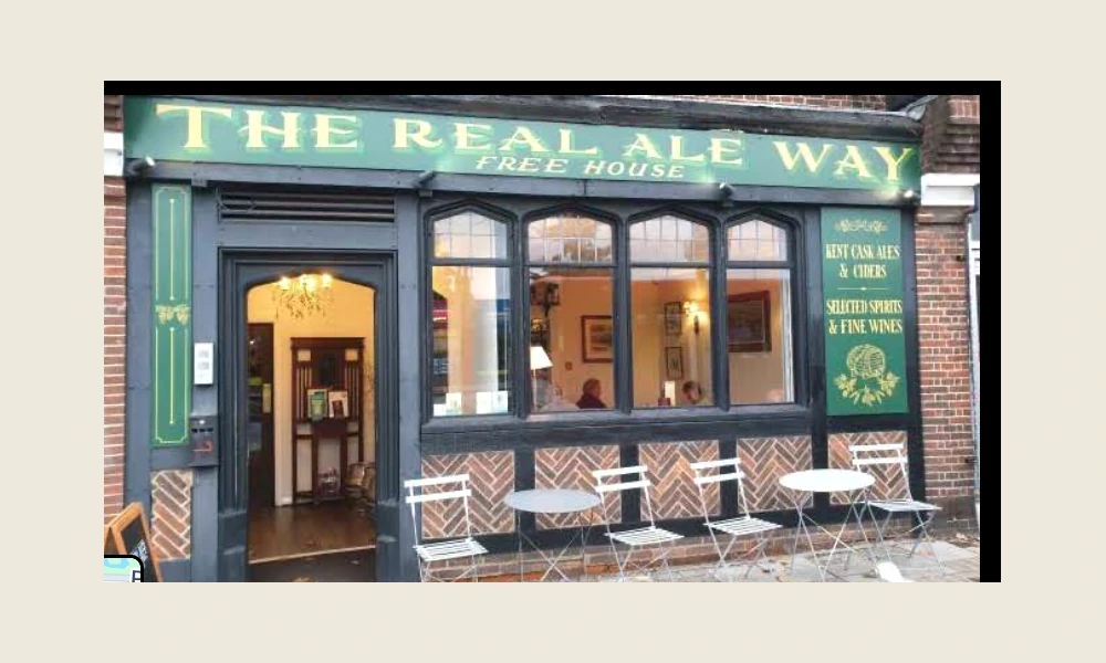 Green and gold Real Ale Way frontage on Station Approach